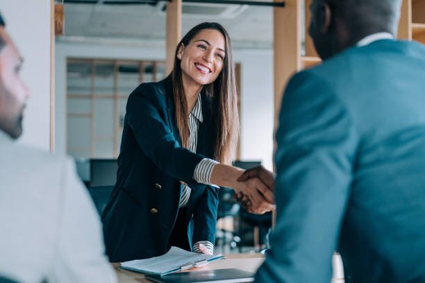 Entrepreneur planning strategy with Infinity Skies experts. Business people shaking hands in the office. Group of business persons in business meeting. Three entrepreneurs on meeting in board room. Corporate business team on meeting in modern office. Female manager discussing new project with her colleagues. Company owner on a meeting with two of her employees in her office.